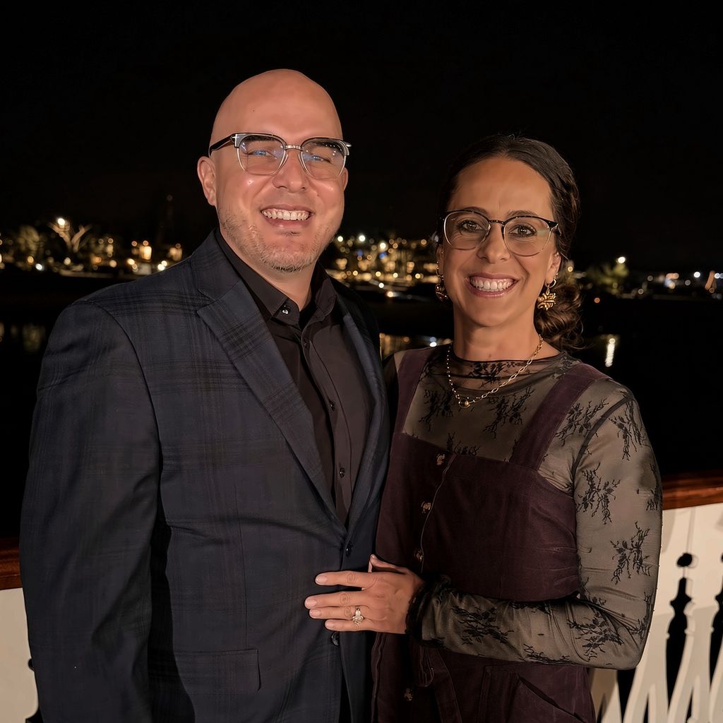 Giusseppe with his wife, smiling at night